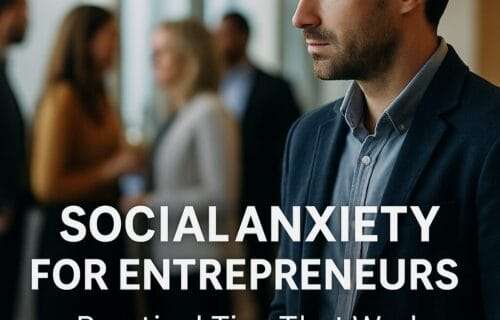 A professionally dressed man stands slightly apart at a networking event, looking thoughtful while others converse in the background. Text overlay reads "Social Anxiety for Entrepreneurs – Practical Tips That Work."