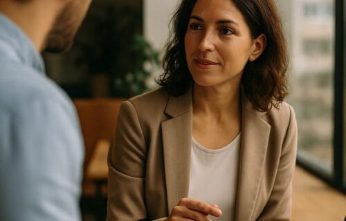 Woman in a modern office leading a mindful conversation with a colleague