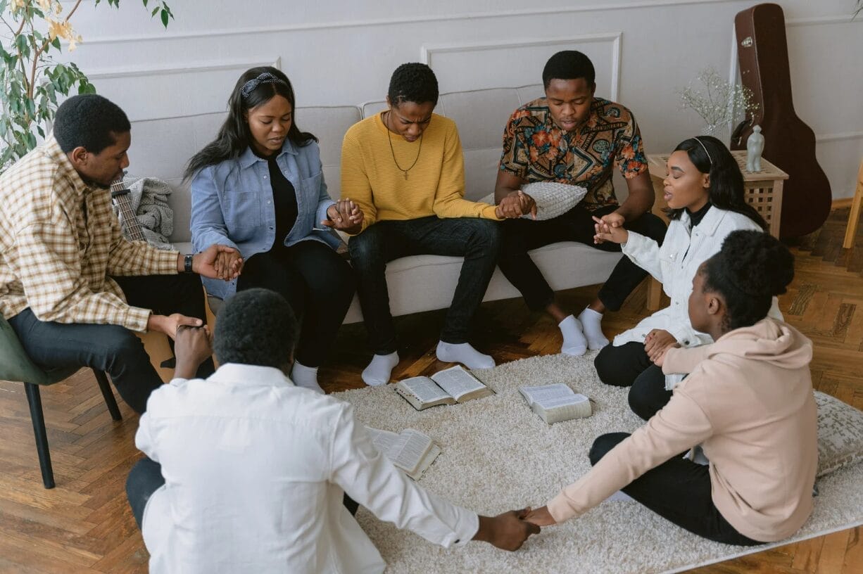 people praying together at bible study