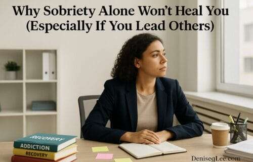 Woman in a professional setting staring out the window with recovery books and notes on the desk, reflecting on sobriety and leadership struggles