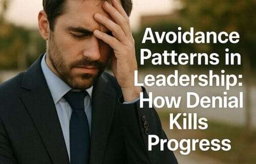 A stressed man in a navy suit stands outdoors with his hand pressed to his forehead, symbolizing frustration and avoidance. The text reads: "Avoidance Patterns in Leadership: How Denial Kills Progress." The background is softly blurred, with deniseglee.com at the bottom.