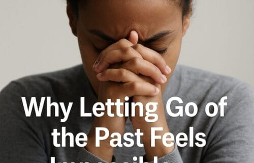 Woman holding her forehead in a moment of reflection and emotional heaviness
