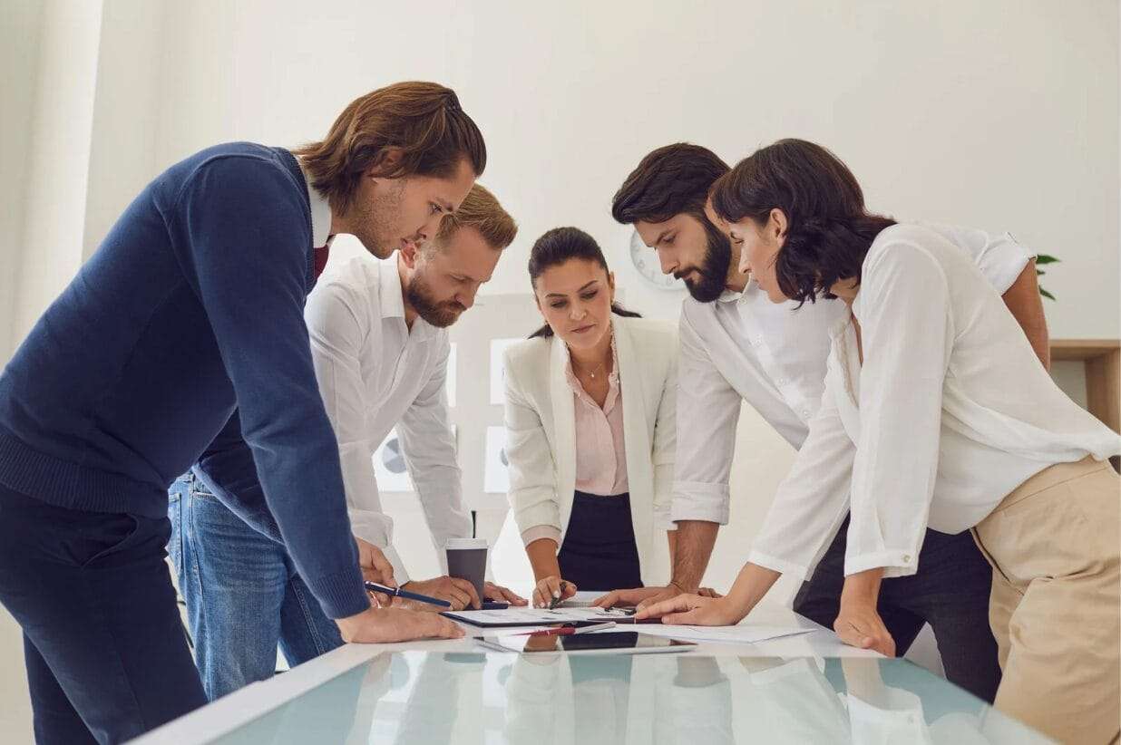 female team leader standing while talking with her team