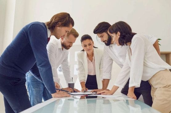 female team leader standing while talking with her team