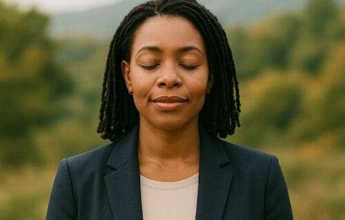African American woman standing calmly in nature with eyes closed, symbolizing grounded spiritual leadership and mindful decision-making