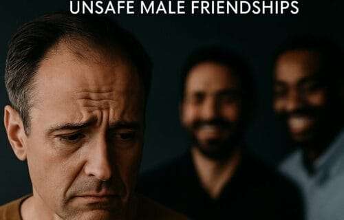 Man sitting among peers but emotionally withdrawn, feeling unseen in a professional setting.