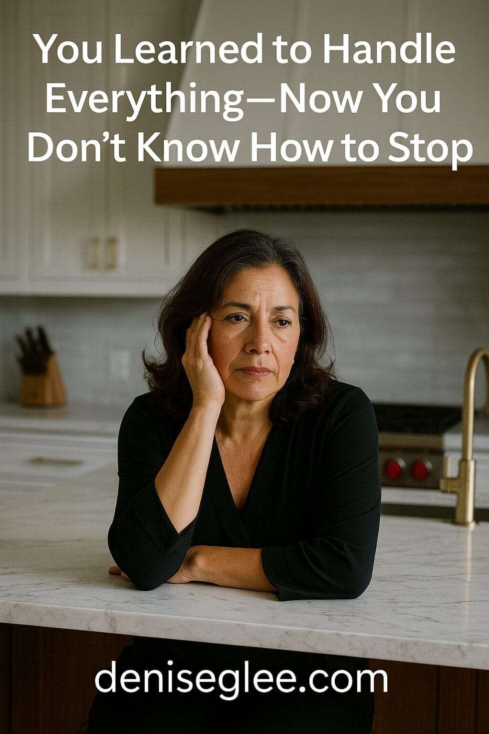 Latina woman in her 50s sitting in a modern kitchen with a weary expression, hand on her face, marble island in front of her