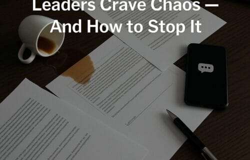 A luxury executive desk in visible disarray — sleek modern design, papers scattered, an espresso tipped over, phone screen lit up with notifications — nobody in the shot, just the evidence of the “always stirring” chaos.