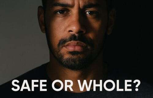 A mixed-race man’s face half in light and half in shadow with overlay text reading ‘Safe or Whole? The Roles That Keep Men Stuck,’ symbolizing the conflict between masculine roles and inner wholeness.